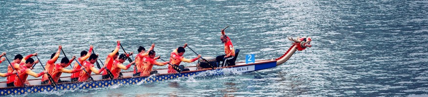 A dragon boat racing on the water.